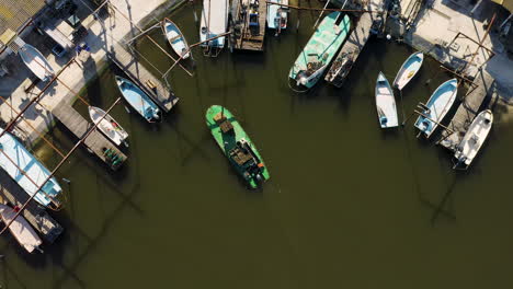 Flat-bottomed-oyster-boat-with-oyster-bags-docking-in-a-fishing-port.-Aerial
